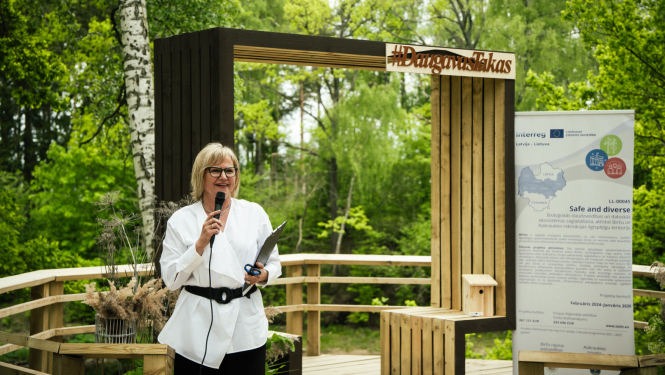 projektu vadītāja runā pa mikrofonu atklāšanas pasākumā