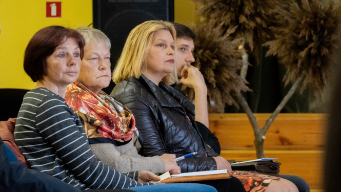 Cilvēki klausās prezentāciju