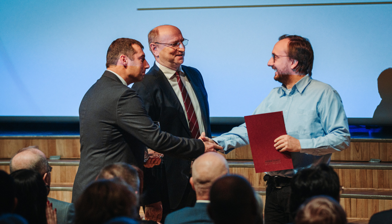 divi vīrieši paspiež rokas