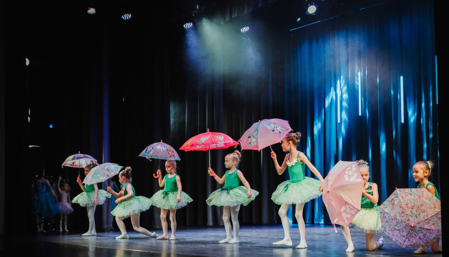 Dejo meitenes ar lietussargiem